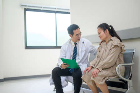 Asian Doctor is working in hospital , talking with sadness woman , medical health care conceptの写真素材