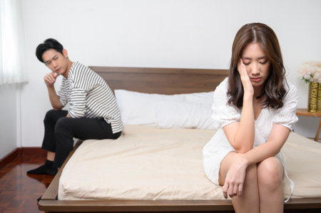 A Young married couple asian husband and wife are arguing, angry couple ignoring each other, relationship trouble concept.の写真素材