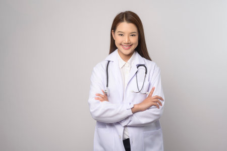 A Portrait of female confident doctor over white background studio, healthcare and Medical technology concept.の写真素材
