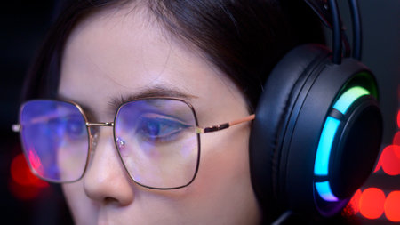 close up of professional Streamer and gamer wearing glasses playing online video games  with monitor...
