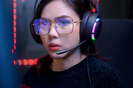 close up of professional Streamer and gamer wearing glasses playing online video games  with monitor reflection in glassesの写真素材