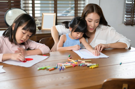 An Asian family with children Drawing and painting on table in playing room at home, Educational game.の写真素材