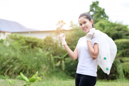 woman is collecting recycling junk on ground , ecological sustainable concept .の写真素材