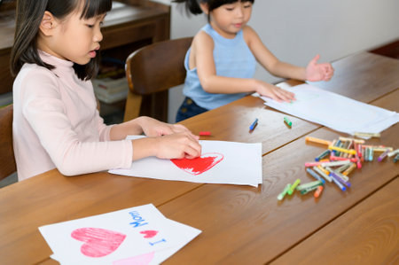 An Asian children Drawing and painting on table in playing room at home, Educational game.