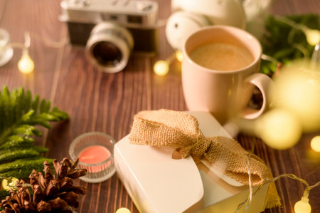 Coffee cup over Christmas lights bokeh in home on wooden table  decorations. Winter  Holiday decoration, Christmas and New yearâs decorations conceptの写真素材