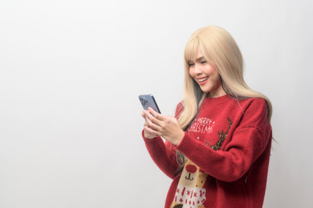 Portrait of happy Caucasian young woman in Christmas sweater over white background