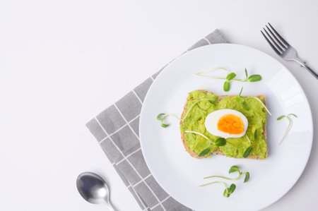Bread with avocado , vegetables fruit and egg on white background , Healthy breakfast conceptの写真素材