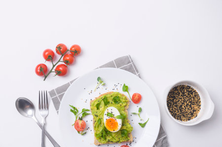 Bread with avocado , vegetables fruit and egg on white background , Healthy breakfast conceptの写真素材