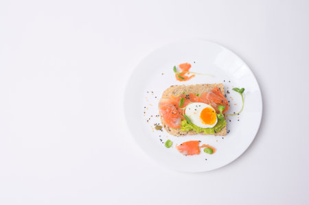 Bread with avocado , vegetables fruit and egg on white background , Healthy breakfast conceptの写真素材