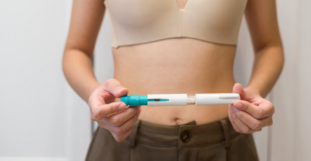 Close up woman using IVF treatment injection on belly to prepare reproductive fertility , Ovulation...