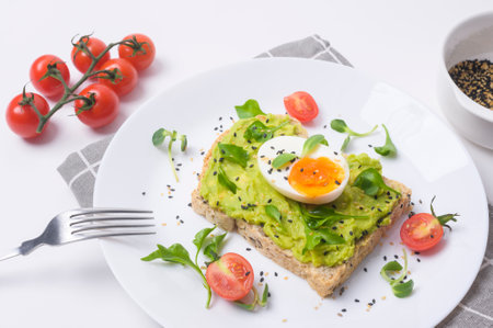 Bread with avocado , vegetables fruit and egg on white background , Healthy breakfast conceptの写真素材