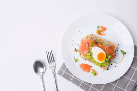 Bread with avocado , vegetables fruit and egg on white background , Healthy breakfast conceptの写真素材