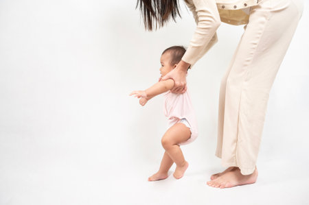 Beautiful mother and adorable baby girl are happy on white background, family, child, childhood and...