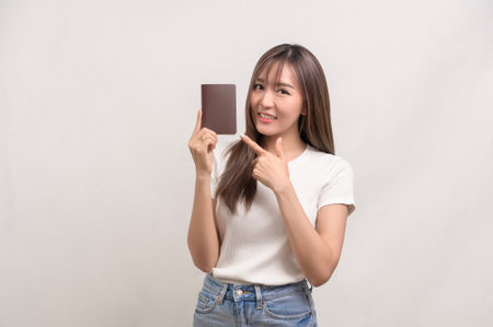 A Young happy asian tourist woman over white background studio, travel and holidays concept.の写真素材