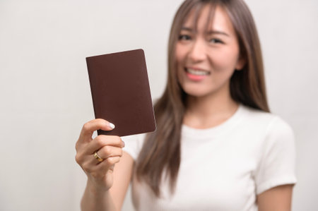 A Young happy asian tourist woman over white background studio, travel and holidays concept.の写真素材
