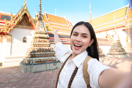 A Beautiful tourist woman on vacation sightseeing and exploring Bangkok city, Thailand, Holidays and traveling conceptの写真素材