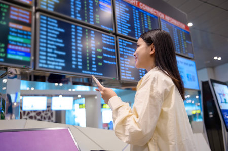 A young beautiful woman walking with suitcase , check in at International airport , vacation travel and transportation conceptの写真素材