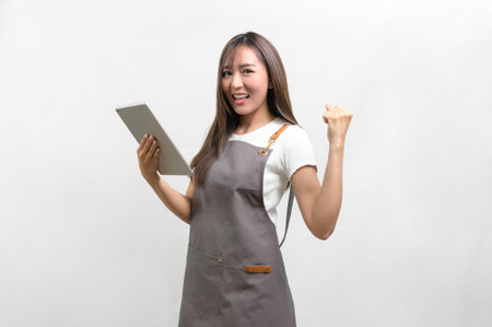 A Portrait of young asian woman wearing apron over white background studio, cooking and entrepreneur conceptの写真素材