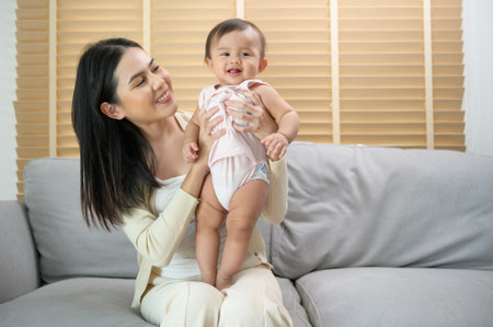 A Portrait of mother and baby girl at home, family, child, childhood and parenthood conceptの写真素材