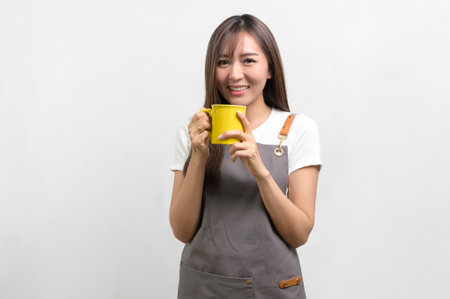 A Portrait of young asian woman wearing apron over white background studio, cooking and entrepreneur conceptの写真素材