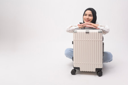 A young muslim woman tourist with baggage  on white backgroundの写真素材