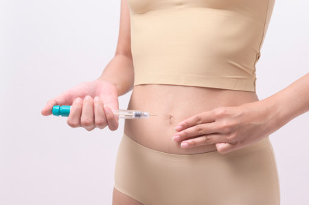Close up woman using IVF treatment injection on belly to prepare reproductive fertility , Ovulation stimulation .の写真素材