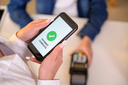 woman customer using QR code payment via smartphone for paying at shop