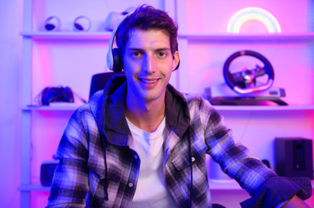 Young Caucasian man Pro Gamer have live streaming  and chatting  with his  fans at homeの写真素材