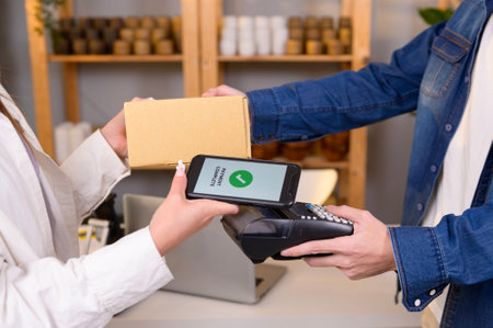 woman customer using QR code payment via smartphone for paying at shopの写真素材