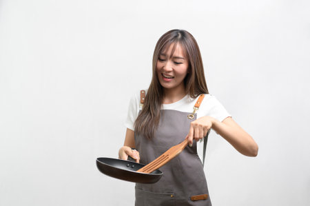 A Portrait of young asian woman wearing apron over white background studio, cooking and entrepreneur conceptの写真素材