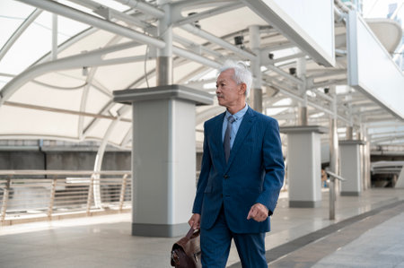 Portrait of Asian senior mature middle aged businessman in modern cityの写真素材