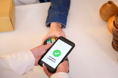 woman customer using QR code payment via smartphone for paying at shopの写真素材