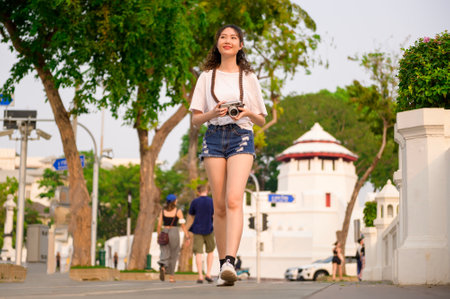 Beautiful young Asian tourist woman on vacation sightseeing and exploring Bangkok city, Thailand, Holidays and traveling conceptの写真素材