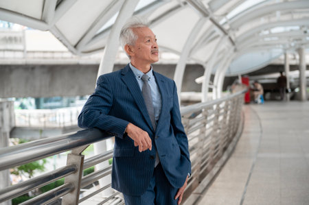 Portrait of Asian senior mature middle aged businessman in modern cityの写真素材