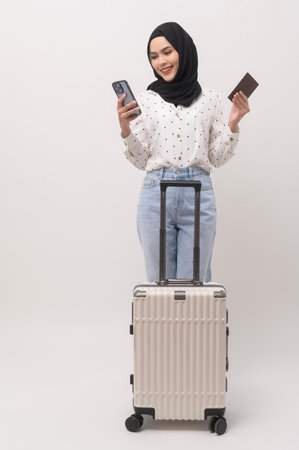A young muslim woman tourist with baggage  on white backgroundの写真素材