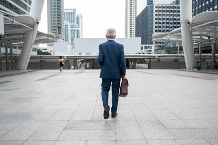Portrait of Asian senior mature middle aged businessman in modern cityの写真素材