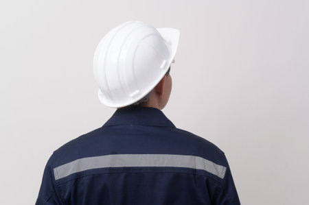 Portrait of male engineer wearing a protective helmet over white background studio.の写真素材