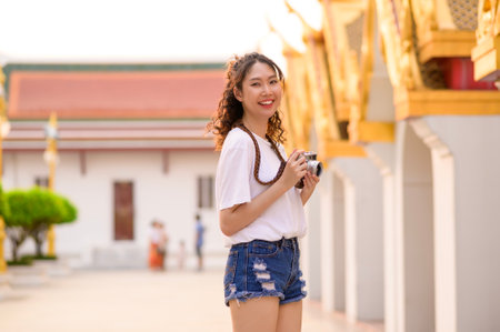 Beautiful young Asian tourist woman on vacation sightseeing and exploring Bangkok city, Thailand, Holidays and traveling conceptの写真素材