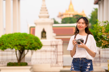 Beautiful young Asian tourist woman on vacation sightseeing and exploring Bangkok city, Thailand, Holidays and traveling conceptの写真素材