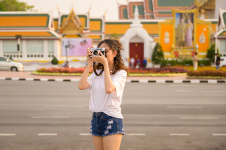 Beautiful young Asian tourist woman on vacation sightseeing and exploring Bangkok city, Thailand,...