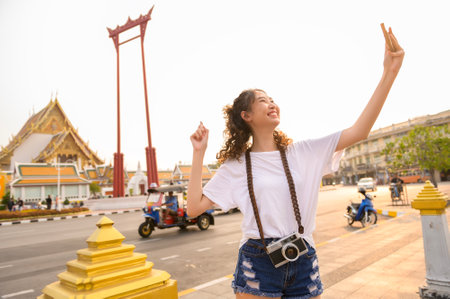 Beautiful young Asian tourist woman on vacation sightseeing and exploring Bangkok city, Thailand, Holidays and traveling conceptの写真素材