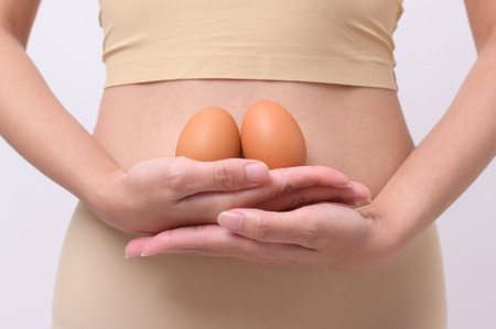 Close up woman holding eggs on belly , prepare reproductive fertility , Ovulation stimulation , matherinty conceptの写真素材