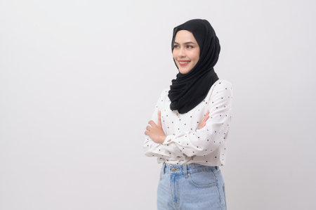Portrait of beautiful muslim woman with hijab over white background studio.の写真素材