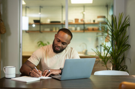 Happy African American man wearing casual clothes working in his homeの写真素材