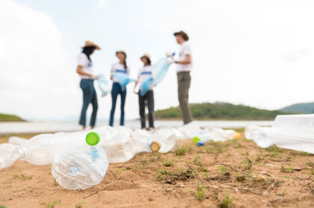Volunteers from the Asian youth community using rubbish bags cleaning  up nature par