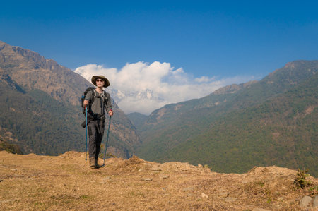 A young traveller trekking on forest trail , Nepalの写真素材