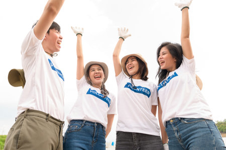 Volunteers from the Asian youth community using rubbish bags cleaning  up nature parの写真素材