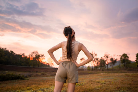 Silhouette woman over golden sunset background feeling happy successful in her life