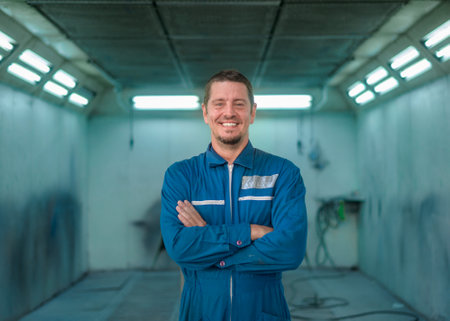 Portrait of Caucasian man in repair mechanic painting shopの写真素材