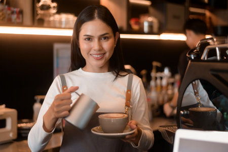 A young woman barista working in modern coffee shopの写真素材